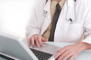 Doctor working on a notebook computer.